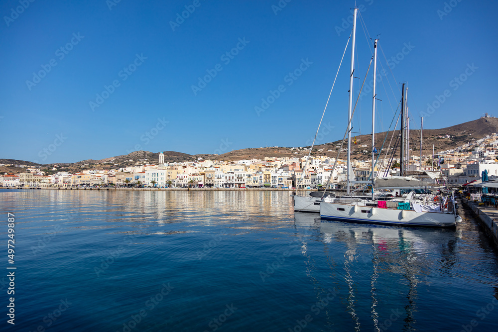 Ermoupoli Syros island Cyclades, Greece. Moored yacht, waterfront building, sunny day, blue sky