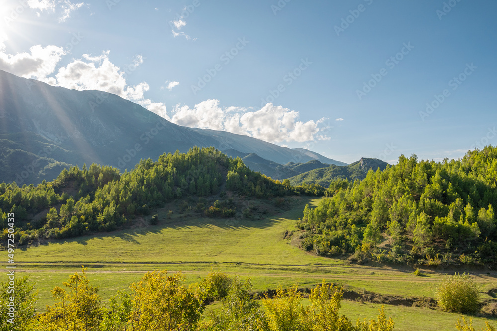 Obraz premium Beautiful mountain valley with gentle hills and agricultutal filds
