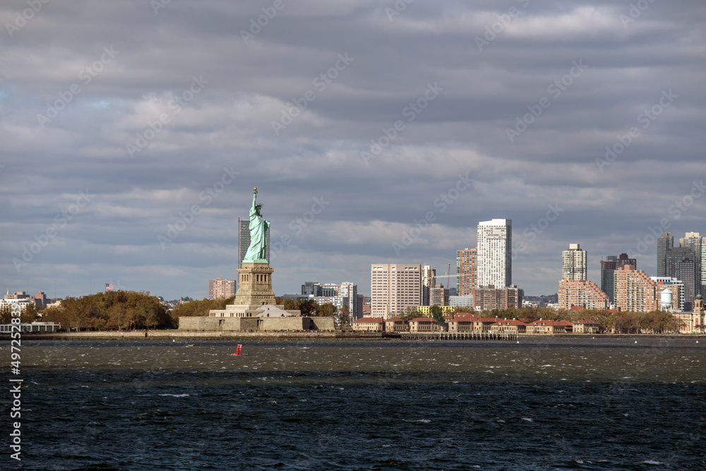 The Statue of Liberty in front of the skyline of Manhattan