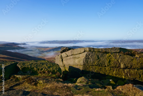 From the top of Stanage Edge mist lingers in the Derbyshire valleys.