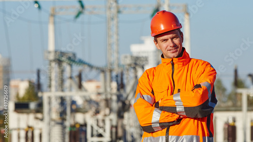 Service engineer worker. Portrait of smiling man in front of electric power distribution station photo