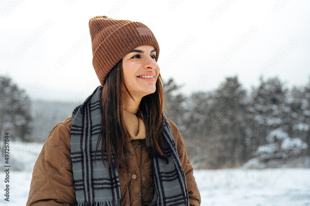 Woman in winter warm jacket walking in snowy winter forest Woman in winter warm jacket walking in snowy winter forest