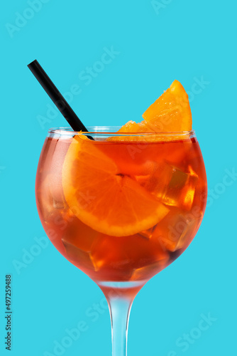 Glass of aperol spritz cocktail on blue background.Close up