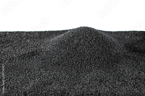 Black fine-grained gunpowder for filling rifle cartridge cases, poured in a small pile, highlighted on a white background. Texture of black gunpowder. photo