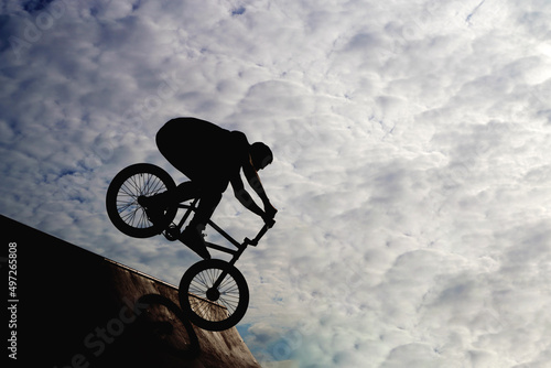 Silhouette of a young man engaged in extreme sports on a bicycle bike. High quality photo