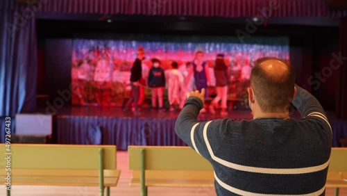Wallpaper Mural unrecognizable drama teacher directing a group of unrecognizable boys and girls in a play in the school theater. Torontodigital.ca
