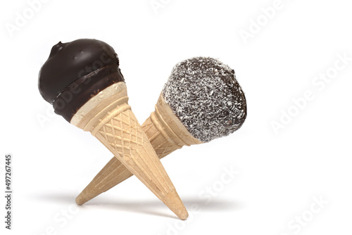 chocolate covered cream cones crossed white background photo