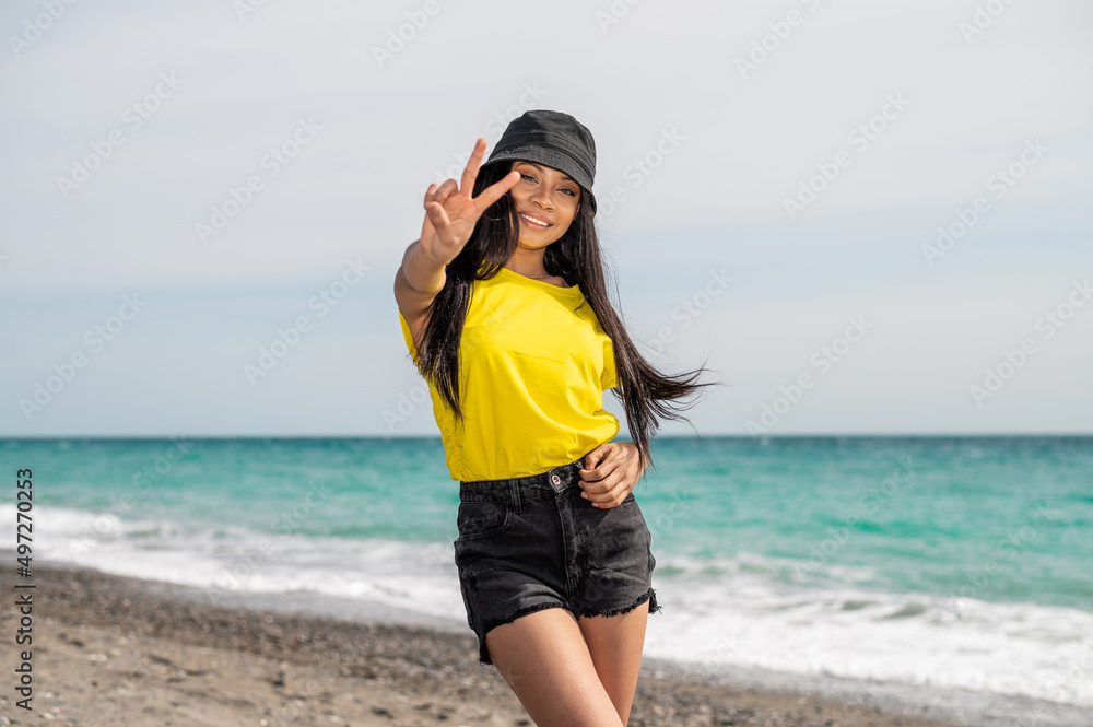Portrait of a Pretty African American woman at the beach on a sunny day - Vacation time concept