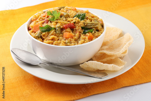 Sambar Rice - Tasty and popular south indian recipe served in a ceramic bowl with appalam or papad