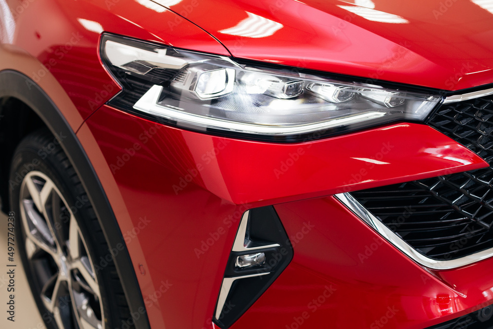 Car headlight of red automobile closeup. Car headlight of red automobile closeup.