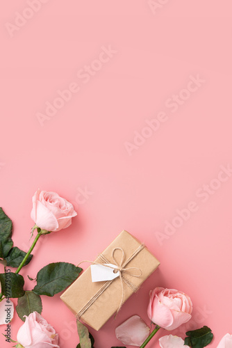 Mother's Day design concept background with pink rose flower and gift on pink background.