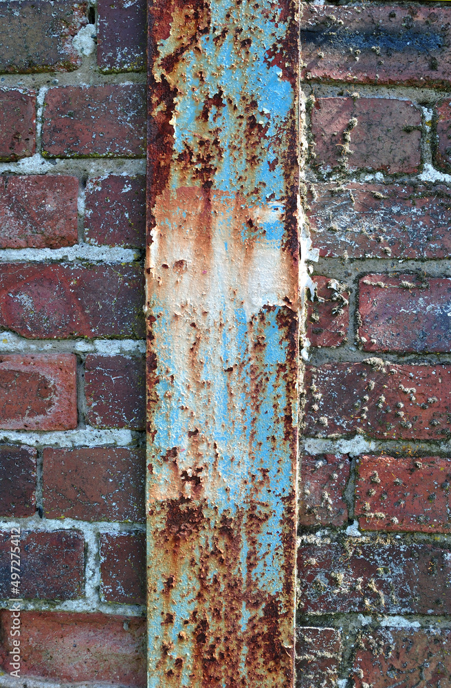 Close Up of Vertical Rusted Iron Beam in Old Brick Wall Close Up of Vertical Rusted Iron Beam in Old Brick Wall