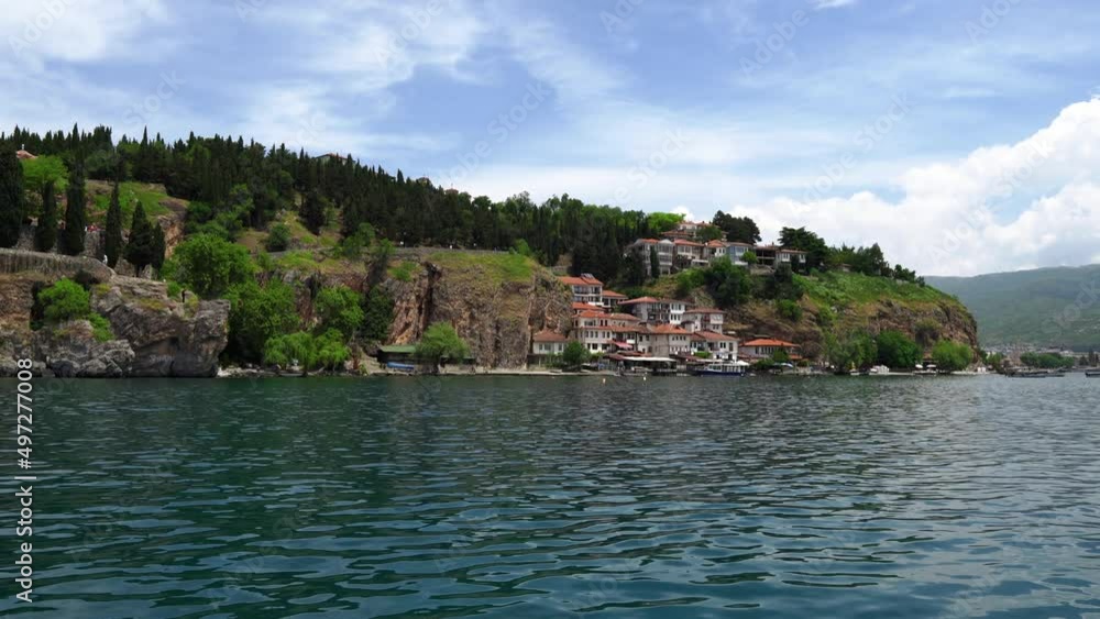 Picturesque view from the lake to Ohrid. City of Ohrid in North Macedonia. A city on the eastern shore of Lake Ohrid. Green mountains of North Macedonia. The deepest and oldest lake in the Balkans Picturesque view from the lake to Ohrid. City of Ohrid in North Macedonia. A city on the eastern shore of Lake Ohrid. Green mountains of North Macedonia. The deepest and oldest lake in the Balkans