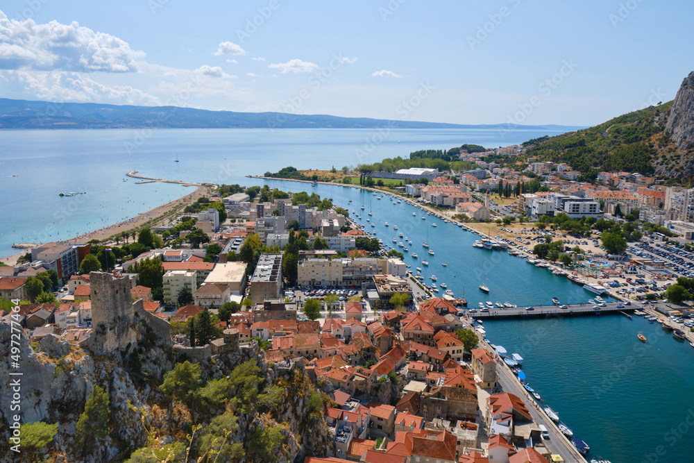 Aerial view of Omis city in Croatia and Cetina river, on blue sky Summer day. Tourism.