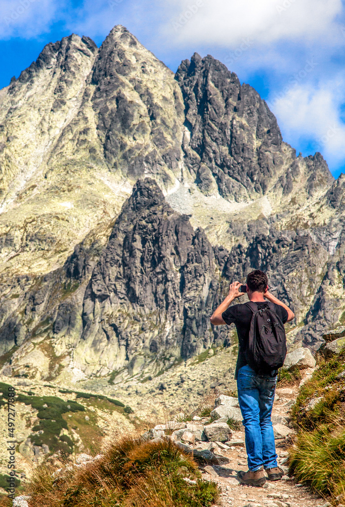 Hiker watching and shooting peaks in High Tatras mountains , Slovakia