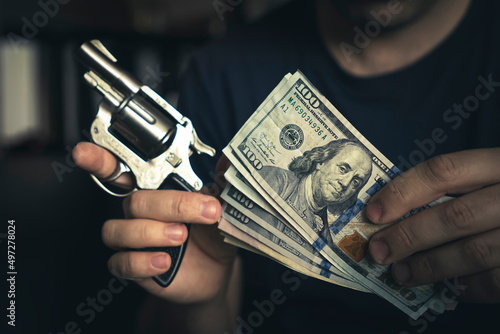 Canvas Print concept robbery. the robber keeps a gun and cash in the river