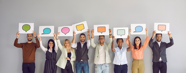 Diverse multiracial multiethnic people show various paper sheets and cards with pictures of different colorful mockup messenger and social media chat icons and message bubbles. Communication concept