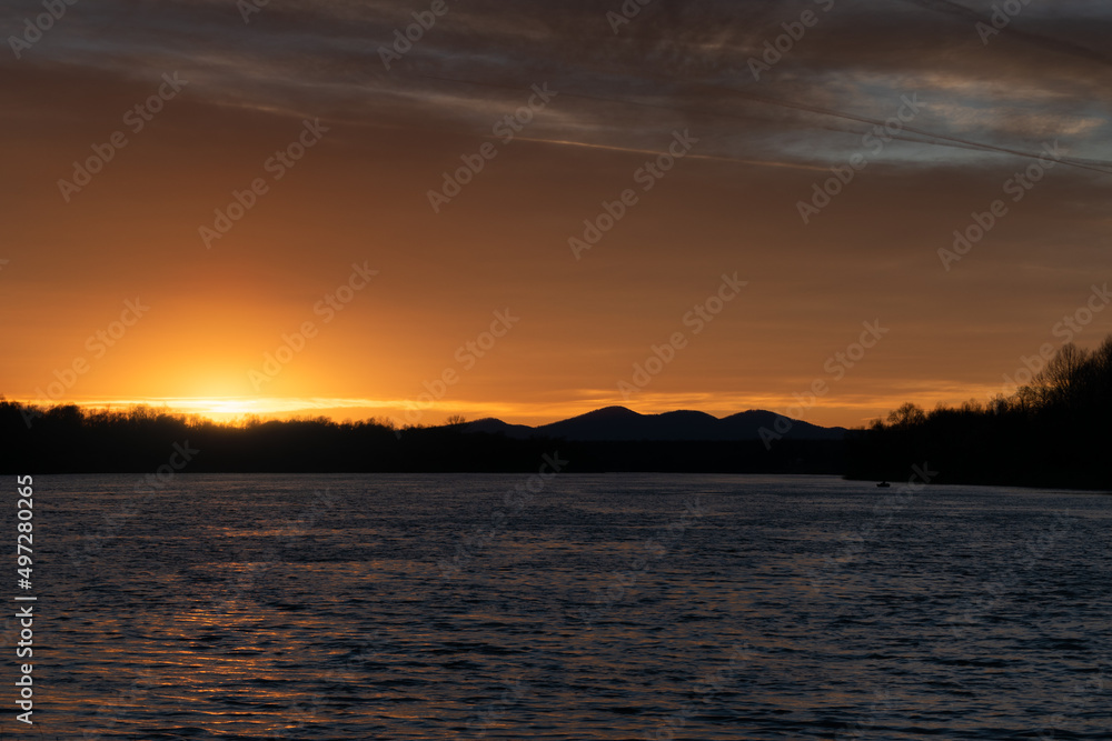 Landscape with Sava river and mountain Motajica silhouette during sunset Landscape with Sava river and mountain Motajica silhouette during sunset