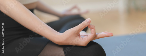 Workout, calm asian young woman, girl hand in calm pose sitting practice meditating in lotus position on mat at home, meditation, exercise for wellbeing, healthy care. Relaxation, happy leisure.