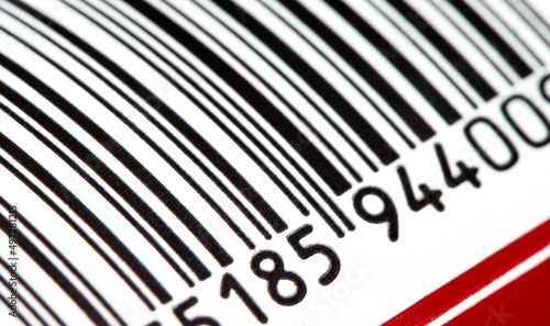 Part of a barcode on a simple drink tin can, bar code tag label object rolling in, detail, macro, extreme closeup, nobody. Food products origin, retail business and consumerism abstract concept