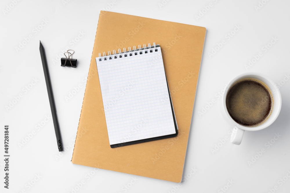 Cup of coffee and notepad on white background Cup of coffee and notepad on white background