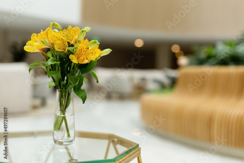 A vase with beautiful yellow flowers in the interior.