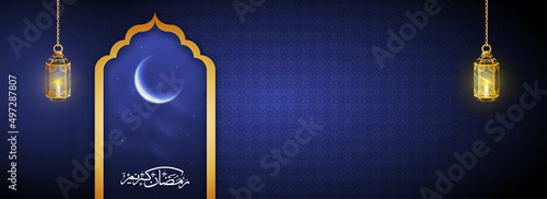 Arabic Calligraphy Of Ramadan Kareem With Glossy Crescent Moon And Golden Lit Lanterns Hang On Blue Islamic Pattern Background.