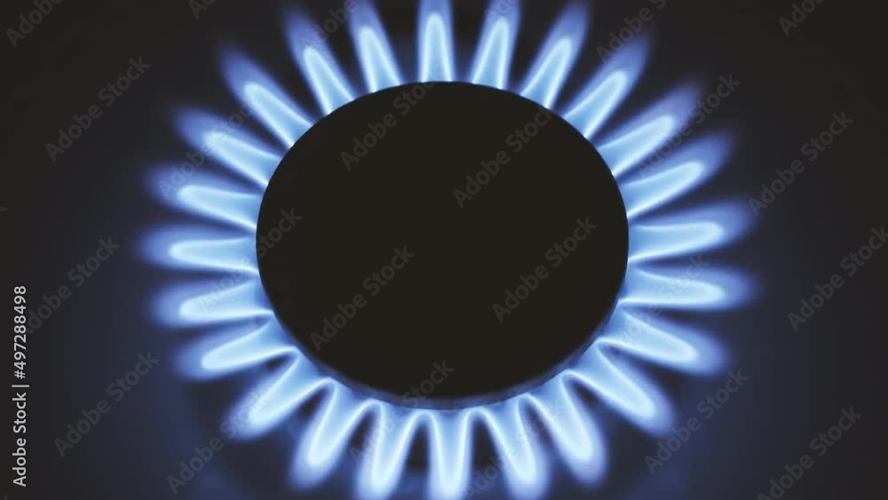 Burning gas stove hob, blue flames macro close-up in the dark on a black background. 4k raw video with smooth camera movement. Burning gas stove hob, blue flames macro close-up in the dark on a black background. 4k raw video with smooth camera movement.