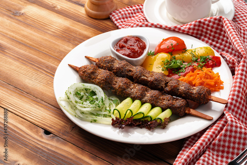 Delicious lula kebab on a wooden table