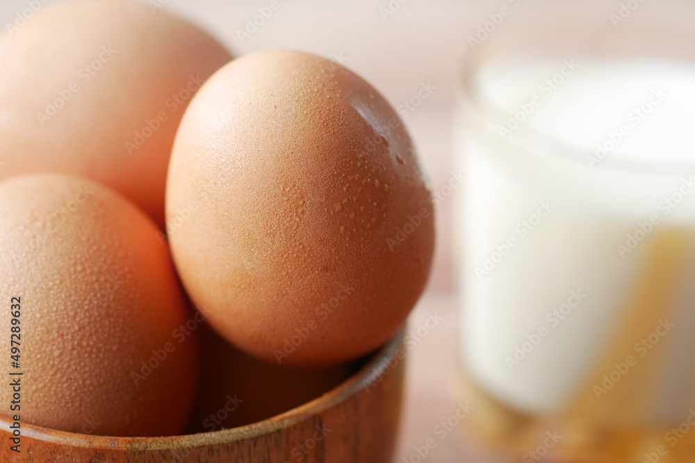 eggs in a bow and a glass of milk on table eggs in a bow and a glass of milk on table
