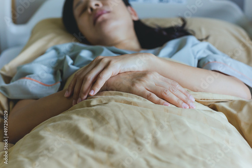 Woman patient lying on the hospital bed.