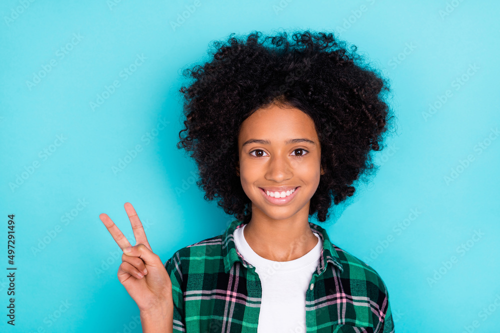 Photo of cheerful friendly nice small lady show v-sign wear checkered shirt isolated turquoise color background Photo of cheerful friendly nice small lady show v-sign wear checkered shirt isolated turquoise color background