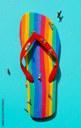 Fotografija miniature men on a rainbow-patterned flip-flop