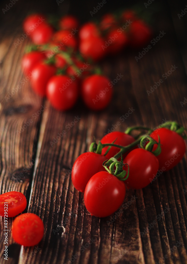 Cherry tomatoes on the table in low key Cherry tomatoes on the table in low key