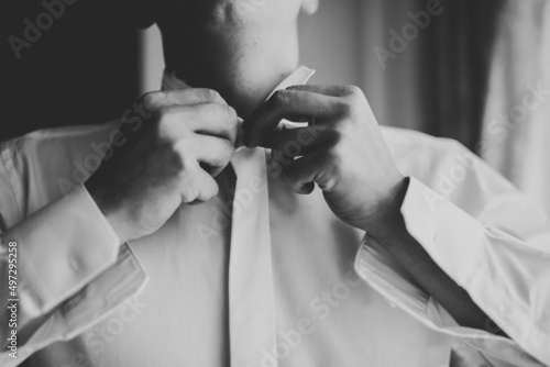 Grooms morning preparation. Handsome man getting dressed and preparing for the wedding photo