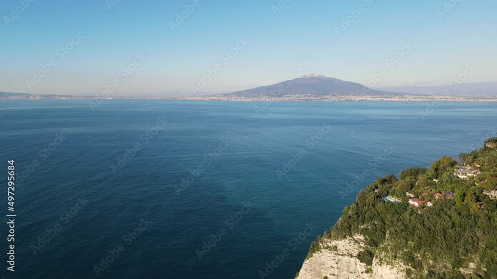 View of the Vesuvius volcano. Aero filming, a copter flying over the sea with a view of the Vesuvius volcano. View of the Vesuvius volcano. Aero filming, a copter flying over the sea with a view of the Vesuvius volcano.