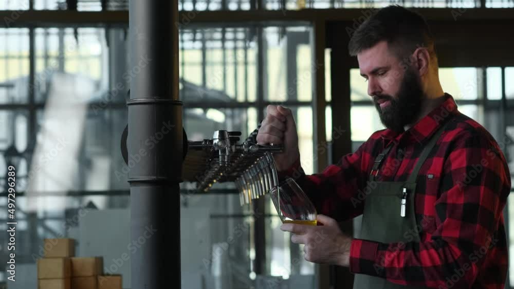 Brutal bartender pouring beer into a glass Brutal bartender pouring beer into a glass
