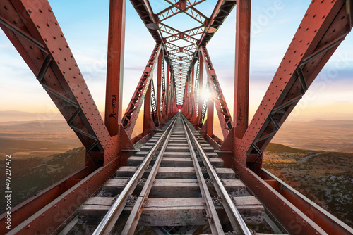 Fototapeta Naklejka Na Ścianę i Meble -  Red Railway Bridge against beautiful sunset view.