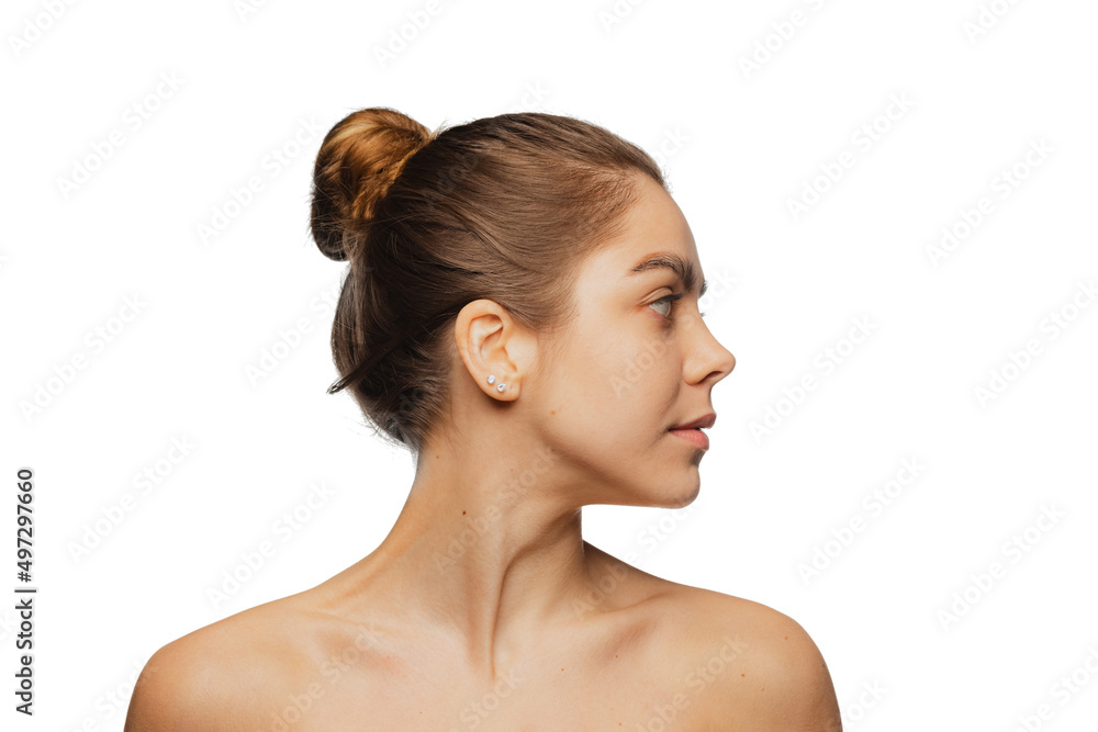 Close-up portrait of young beautiful girl with no makeup isolated over white studio background. Natural beauty concept. Close-up portrait of young beautiful girl with no makeup isolated over white studio background. Natural beauty concept.