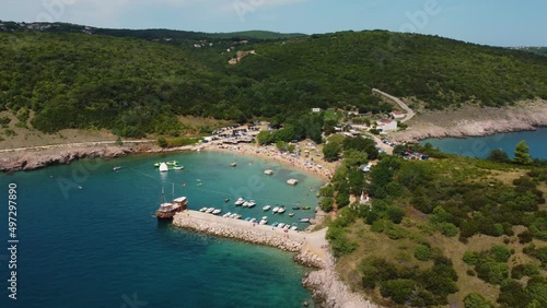 Aerial view of packed Risika Beach on Krk island in Croatia with a pirate ship in summertime photo