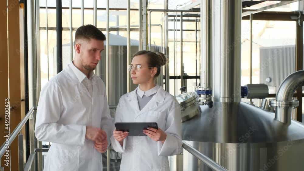 An experienced production technologist trains an intern An experienced production technologist trains an intern