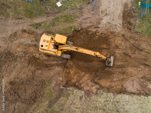 Aerial view of digger on house build construction site photo