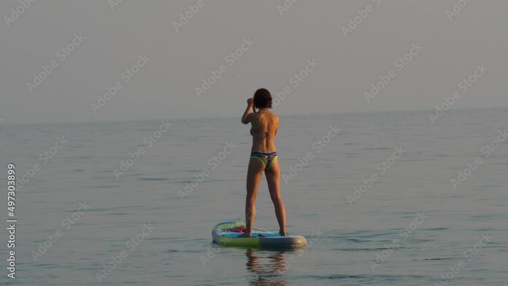 Fit girl in bikini on SUP. Stand up paddle. Fit girl in bikini on SUP. Stand up paddle.