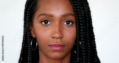 Portrait black African teen girl looking at camera, close-up face