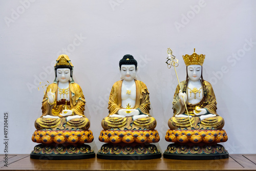 Golden Buddha statues on the table photo