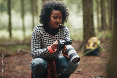 Woman checking her photos while hiking photo