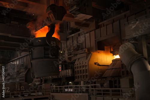 A Bessemer converter in a steel mill full of liquid steel photo
