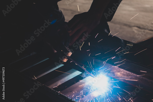 welder, welding automotive part in a car factory