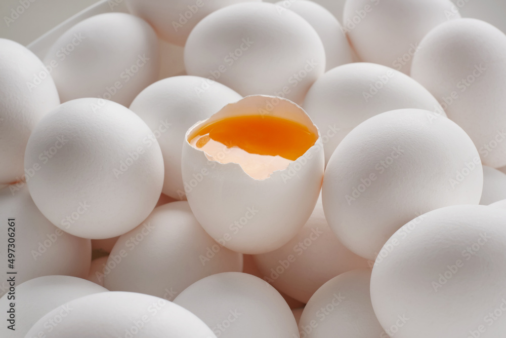 Group of white eggs, whole and broken egg. Cracked egg, eggshells with yolk. Shallow depth of field Group of white eggs, whole and broken egg. Cracked egg, eggshells with yolk. Shallow depth of field
