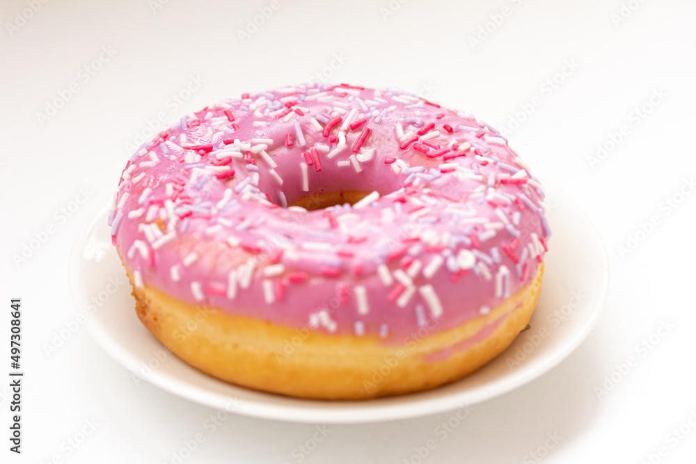 Pink Donut, doughnut with colorful sprinkles on white background.